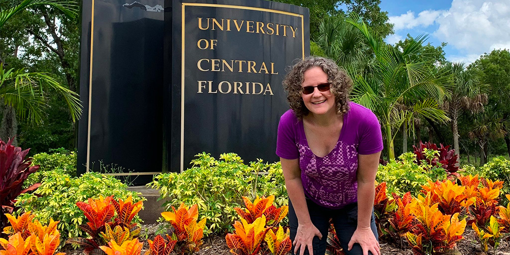 Betsy Kalin posing in front of a UCF sign. Originally posted on Twitter.